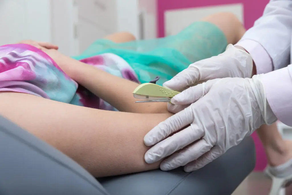 doctor inserting contraceptive implant into a patients arm at a reproductive health clinic in boulder